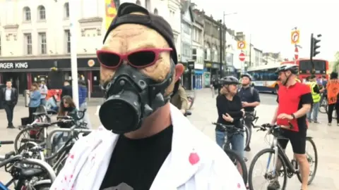 A man in a pretend gas mask and sun glasses