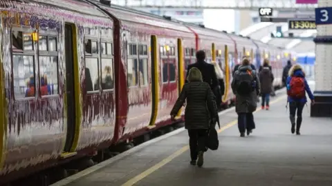 Getty Images passengers on a train platform