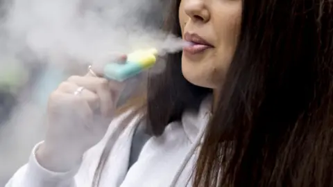 TOLGA AKMEN/EPA-EFE/REX/Shutterstock Girl vaping