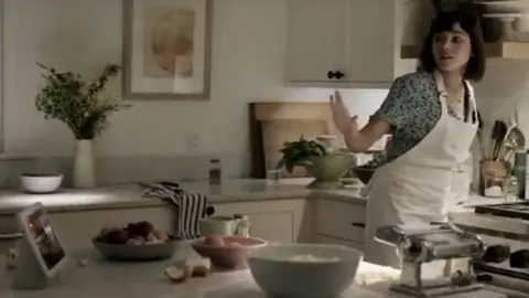 Google woman silences Google Nest with her hand