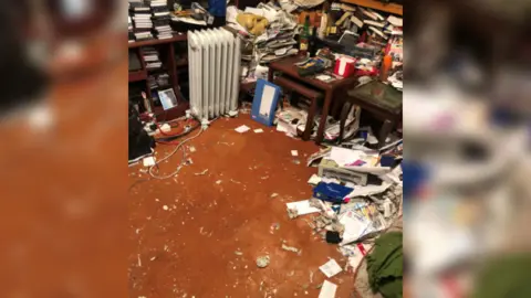 Making Space A room with lots of clutter built up around the edges but a space cleared on the carpet in the middle