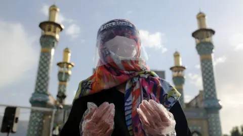 Getty Images A worshipper in Tehran, Iran wears protective equipment