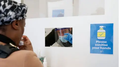 Getty Images Sandra Husbands taking swab for rapid Covid test