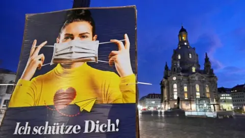 Reuters A poster reads "I protect you" during the local coronavirus disease (COVID-19) lockdown in Dresden, Germany, December 14, 2020