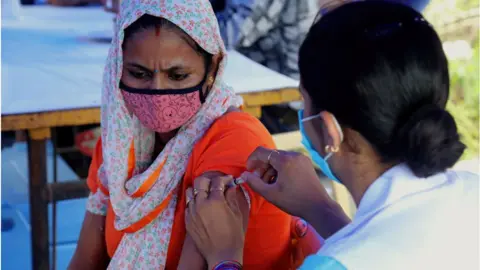 Getty Images A woman being vaccinated in India