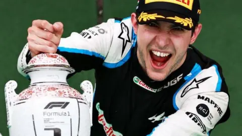 Esteban Ocon holds his winners trophy at the Hungarian Grand Prix