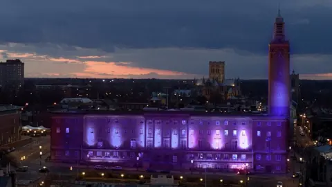 Norwich City Council City Hall in Norwich lit purple.