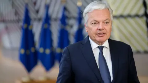 Getty Images Didier Reynders speaking to reporters