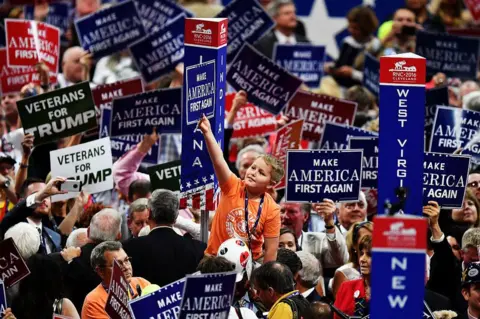 Getty Images Trump supporters hold up signs that read "Make America First Again" during the Republican National Convention on July 20, 2016