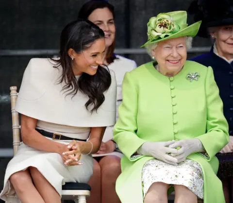 Getty Images Meghan, Duchess of Sussex and Queen Elizabeth II attend a ceremony