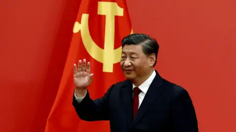 Getty Images Xi Jinping waves after his speech as the new Politburo Standing Committee members meet the media following the 20th National Congress of the Communist Party of China, at the Great Hall of the People in Beijing, China October 23, 2022.