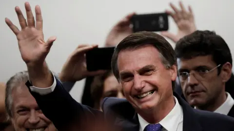 Reuters Presidential candidate Jair Bolsonaro waves to crowds during a ceremony in Brasilia, Brazil on 7 March 2018