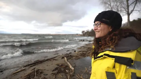 David A. Seaver Cora Ball founder Rachael Miller on a beach