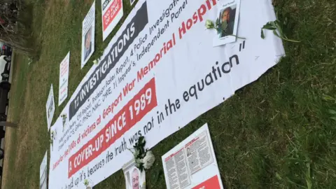 Family tributes and protest banners outside Portsmouth Cathedral