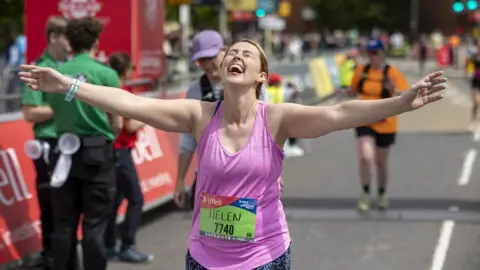 The AJ Bell Great Bristol Run  Female runner finishes the Great Bristol Run