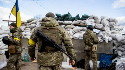 Reuters Ukrainian service members are seen, after Russia launched a massive military operation against Ukraine