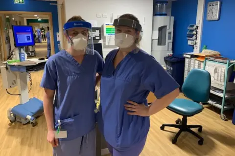 John Wright Two nurses wearing hospital scrubs