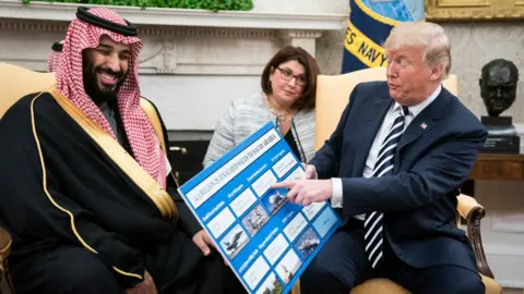 Getty Images US President Donald Trump (R) holds a defence sales chart with Saudi Arabia's Crown Prince Mohammed bin Salman in the Oval Office of the White House on March 20, 2018