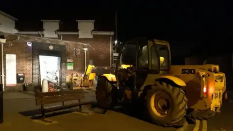 Nottinghamshire Police JCB near damaged shop