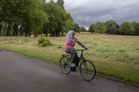 Alison Baskerville Haseena Aktar riding a bicycle