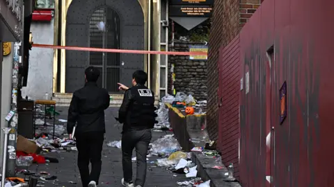 Getty Images Two police officers walk down an alley in Itaewon two days after the crush that killed 156 people