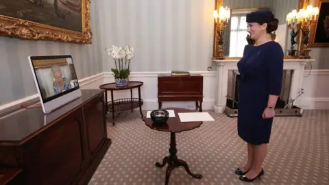 PA Media Ivita Burmistre, ambassador from Latvia, smiles during a virtual audience with the Queen