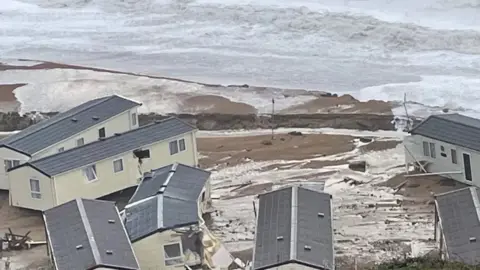 Scattered mobile homes in flood water at Burton Bradstock