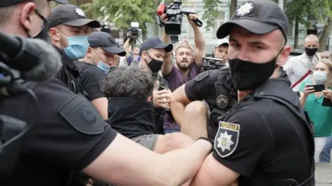 EPA Ukrainian policemen detain a man during protests