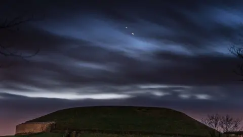 Jupiter and Saturn pictured over Newgrange in County Meath