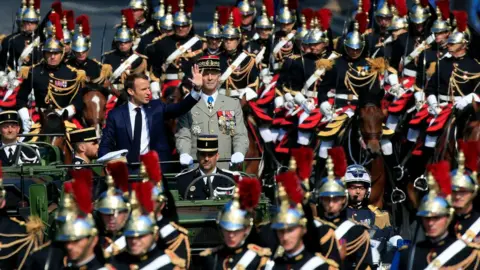 Reuters President Macron rides with the French army chief of staff