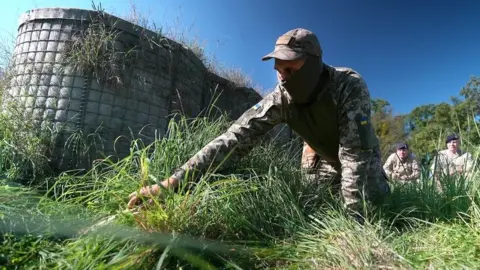 Ukrainian solder on the ground during training