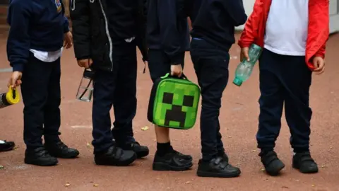 Getty Images Children in a queue outside school