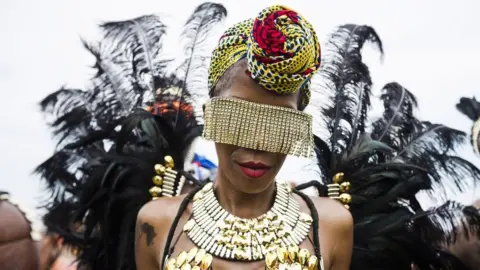 Revellers take part in the Caribbean Carnival Grand Parade in Toronto