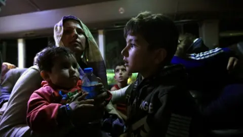 Reuters Syrian displaced families, who fled violence after the Turkish offensive against Syria, sit in a bus after arrival at a refugee camp in Bardarash on the outskirts of Dohuk, Iraq October 17,