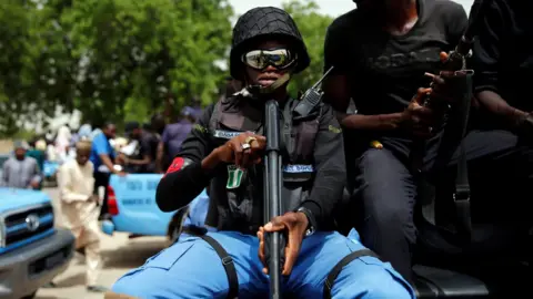 Reuters A member of the local militia, otherwise known as CJTF, Baba Gana, holds a gun as he sits in the back of a truck during a patrol in the city of Maiduguri, northern Nigeria June 9, 2017.