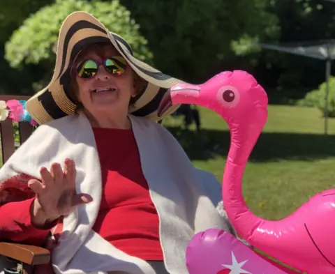 Old Vicarage Iola Roberts with a pink inflatable flamingo at the "beach party"