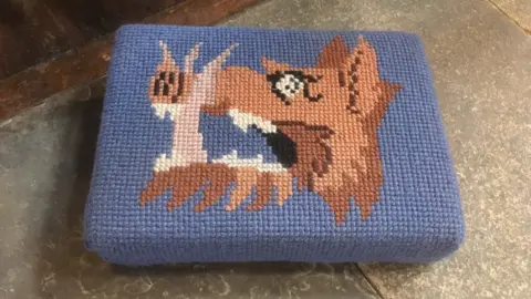 A boar's head on a kneeler at Bradford Cathedral