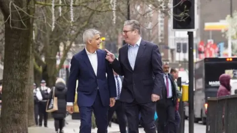 PA Media Sadiq Khan and Sir Keir Starmer laugh as they leave Mr Khan's launch event in Westminster