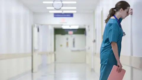 Getty Images Doctor feeling stressed at work