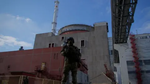 Getty Images A Russian soldier stands guard outside Zaporizhzhia nuclear power plant