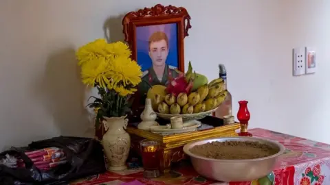 Linh Pham/Getty Images A shrine with a photo of Nguyen Dinh Tu