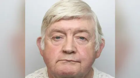 Kevin Gleeson, with grey hair, in police mug shot