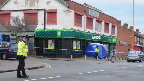 PA Police officers outside the Paddy Power shop