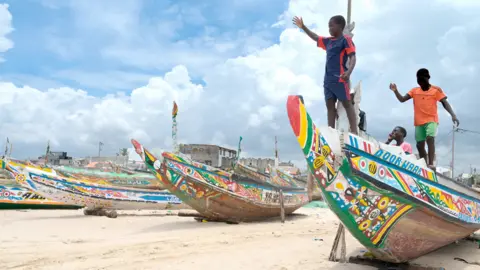 Seyllou/AFP Young boys play on a pirogue in Fass Boye, Senegal - Thursday 17 August 2023