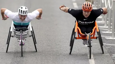 PA Media Two women wheelchair racers go hell for leather down the finishing stretch