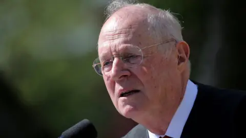 Reuters Supreme Court Associate Justice Anthony Kennedy speaks in front of a microphone