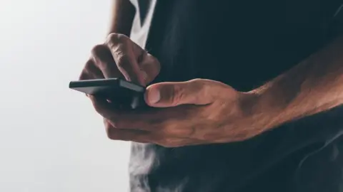 Getty Images Man on his phone