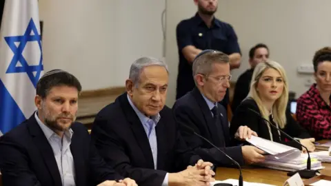 EPA Israeli Prime Minister Benjamin Netanyahu (2nd Left) convenes the weekly cabinet meeting at the defence ministry in Tel Aviv, Israel (7 January 2024)