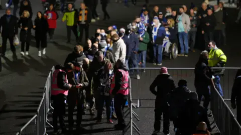 Huw Evans picture agency Football fans queuing to get into a stadium