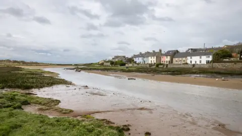 Getty Images A village on the south west coast of Anglesey with houses beside the Afon Ffraw.